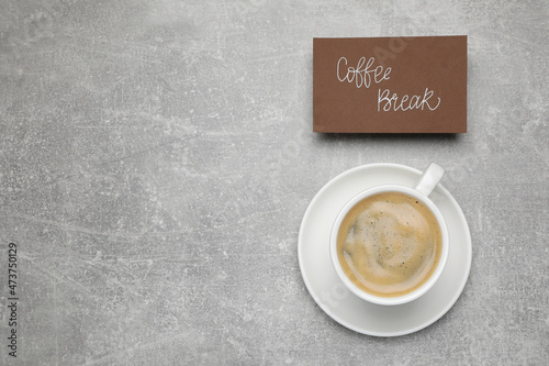 Card with phrase Coffee Break near cup of drink on light grey table, flat lay. Space for text