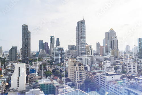 Financial stock chart hologram over panorama city view of Bangkok, business center in Southeast Asia. The concept of international transactions. Double exposure.