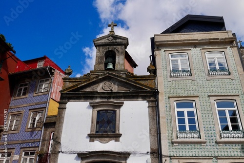 Panoramic view of typical colorful houses with ceramic tiles (azulejos) and chapel at waterfront in Ribeira. Porto, Portugal.