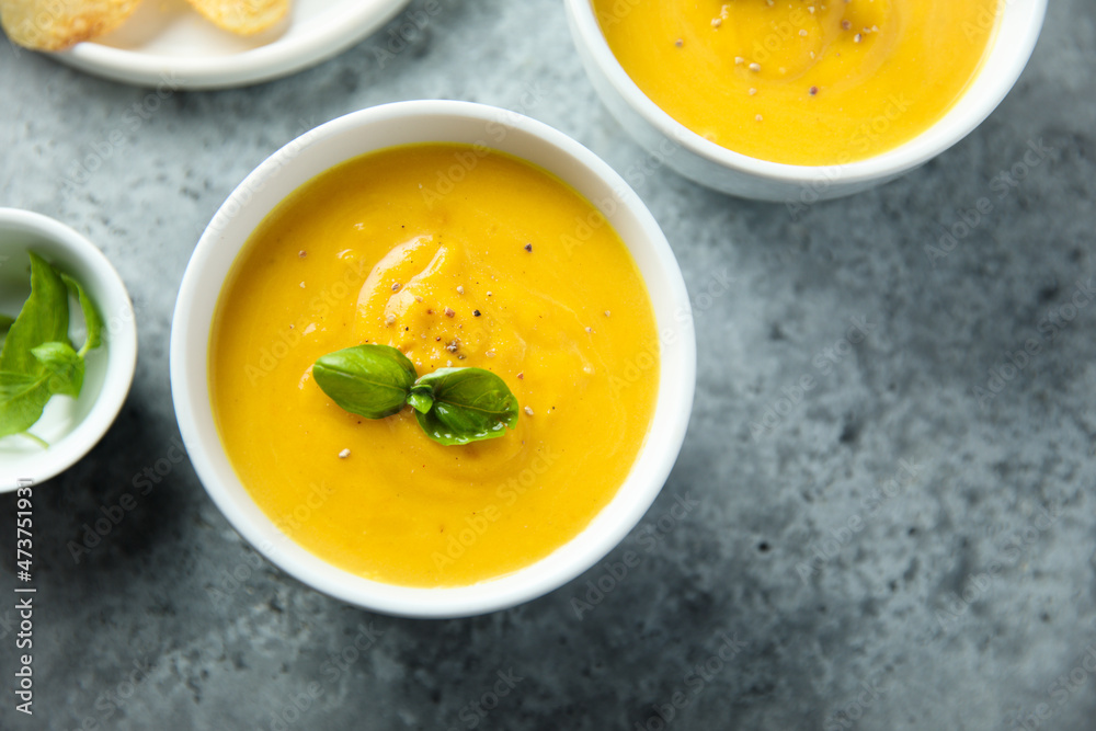 Traditional homemade pumpkin soup with fresh basil Traditional homemade pumpkin soup with fresh basil