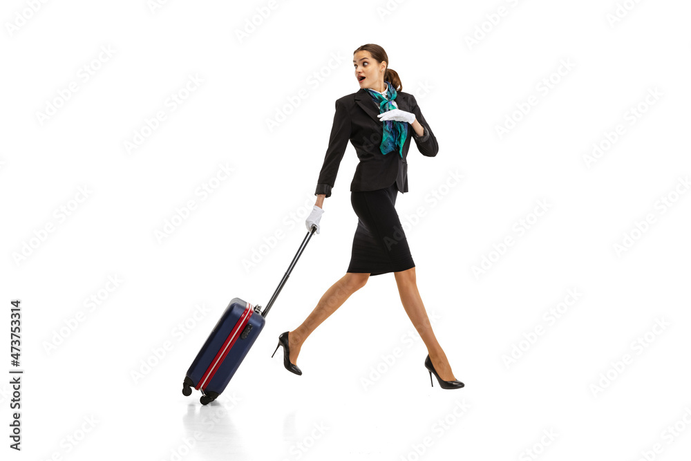 Full-length portrait of beautiful young woman, flight attendant running with suitcase isolated on white studio background. Full-length portrait of beautiful young woman, flight attendant running with suitcase isolated on white studio background.