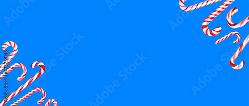 Red and white striped candy cane sticks frame on blue background.