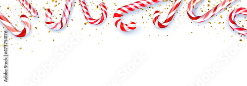 Red and white striped candy cane sticks frame on white background.