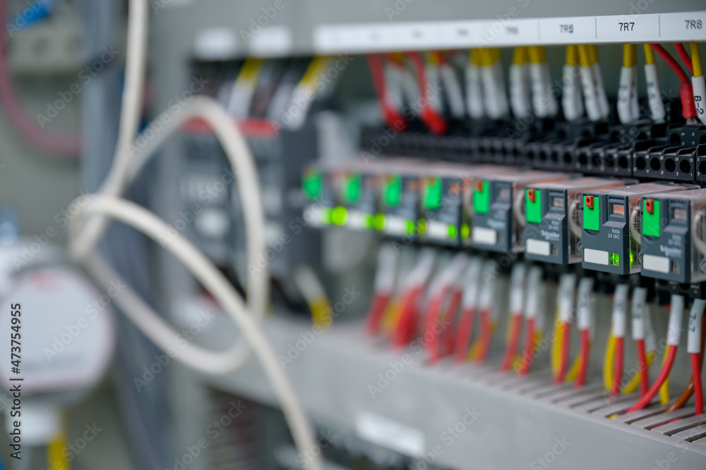 Close-up shot of an industrial electric automatic electrical control box that supplies the power line in an electrical control cabinet. electric background selective focus Close-up shot of an industrial electric automatic electrical control box that supplies the power line in an electrical control cabinet. electric background selective focus