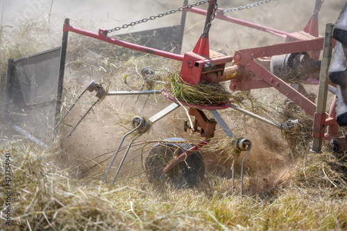 Agricultural tractors are harvesting Pangola grass, where farmers use balers or bales of hay to feed and export to Thailand's agriculture.