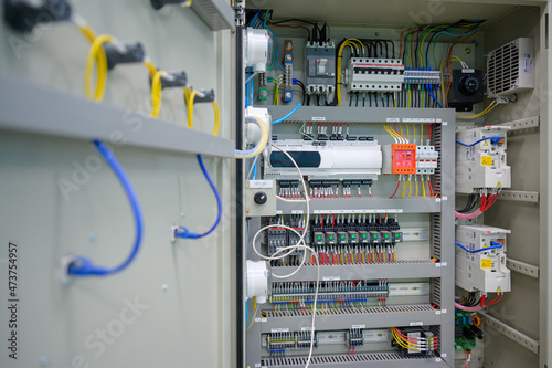 Close-up shot of an industrial electric automatic electrical control box that supplies the power line in an electrical control cabinet. electric background selective focus