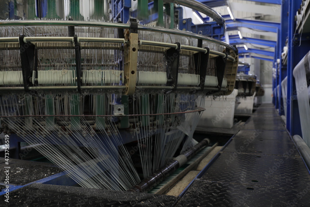 The mechanical equipment of the plastic weaving production line is running in a factory The mechanical equipment of the plastic weaving production line is running in a factory