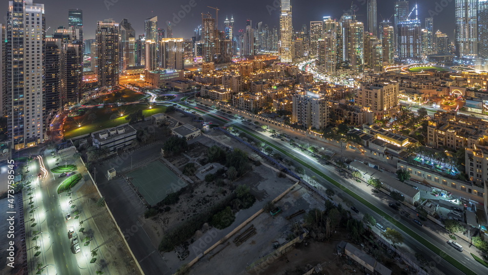 Fototapeta premium Dubai's business bay towers aerial night timelapse. Rooftop view of some skyscrapers