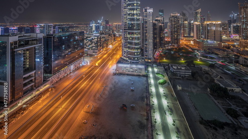 Dubai's business bay towers aerial night timelapse. Rooftop view of some skyscrapers