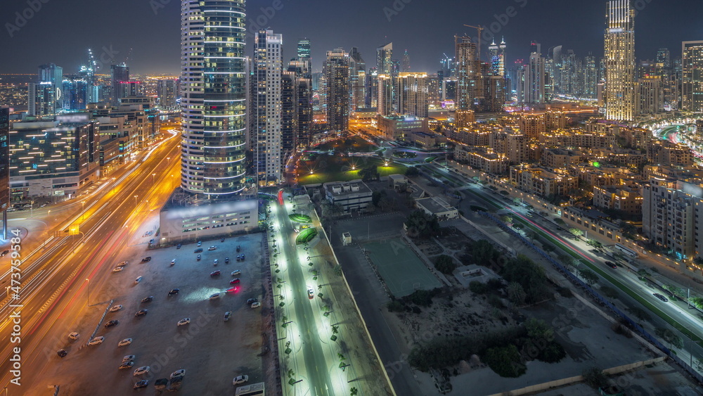 Dubai's business bay towers aerial night timelapse. Rooftop view of some skyscrapers