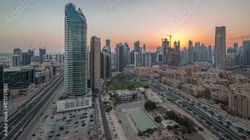 Dubai's business bay towers aerial day to night timelapse. Rooftop view of some skyscrapers © neiezhmakov