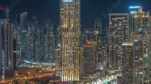 Futuristic aerial all night cityscape timelapse with illuminated architecture of Dubai downtown, United Arab Emirates.