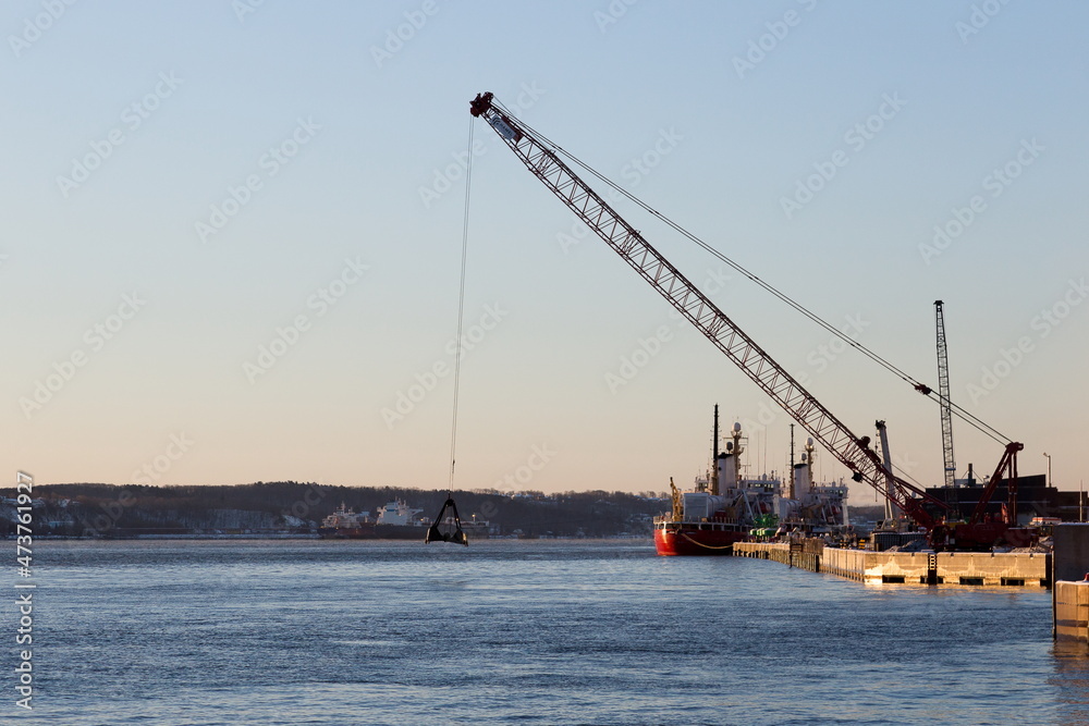 Sunny winter view of large crane hanging over the St. Lawrence river in the old port, Quebec City, Quebec, Canada 