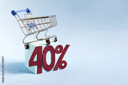 Advertising layout 40% discount. The consumer basket and the figures 40% on a blue background copy space.