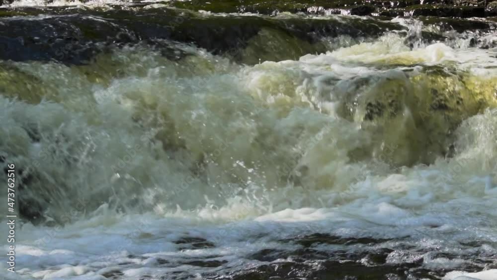Slow motion river water rushing over the rocks; Ocqueoc Falls, rushing water over rocks in Northwest Michigan after months of rain in late summer--late morning. 25 percent of real time. 436 25 Slow motion river water rushing over the rocks; Ocqueoc Falls, rushing water over rocks in Northwest Michigan after months of rain in late summer--late morning. 25 percent of real time. 436 25
