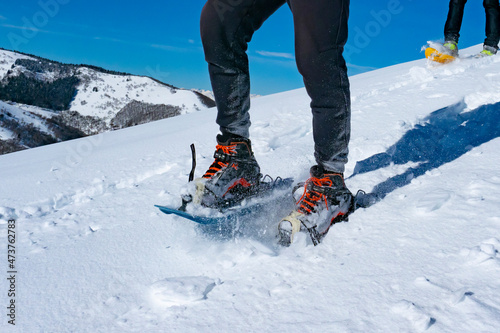Snowshoeing scene in the italian alps