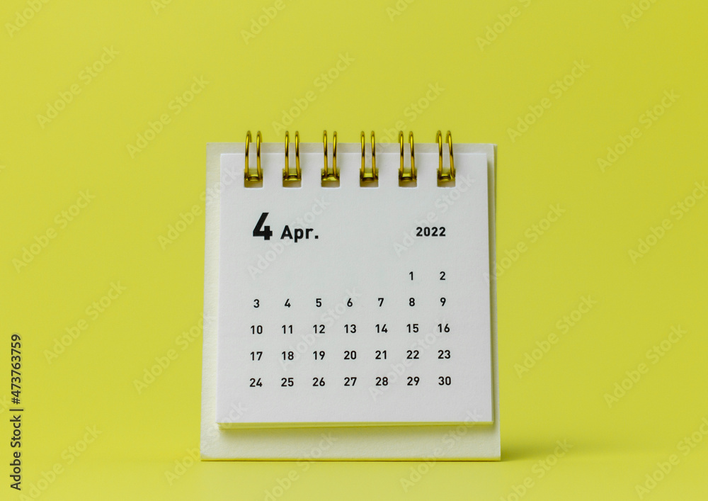 Desktop calendar for April 2022 on a yellow background. - obrazy, fototapety, plakaty 