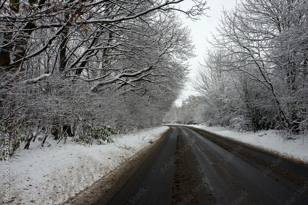 Icy and snowy weather, hazardous road and driving conditions, rural country road