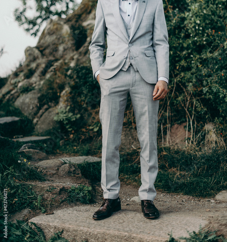 a groom from Brazil wears grey suite, wedding solo man portrait