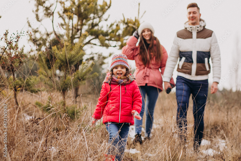 Young family together walking in forest at winter time Young family together walking in forest at winter time