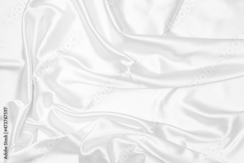 Creases of white satin, silk, and cotton. Abstract white fabric texture background. photo