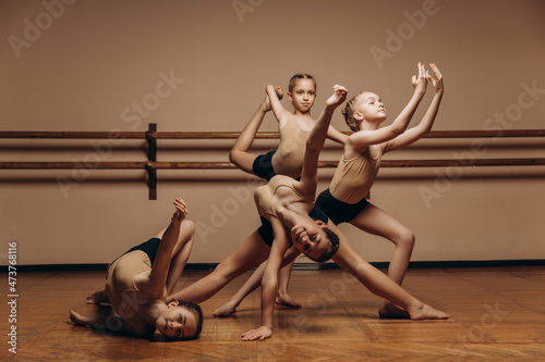 Image of a group of modern little ballerinas standing in a modern dance pose. Copy space