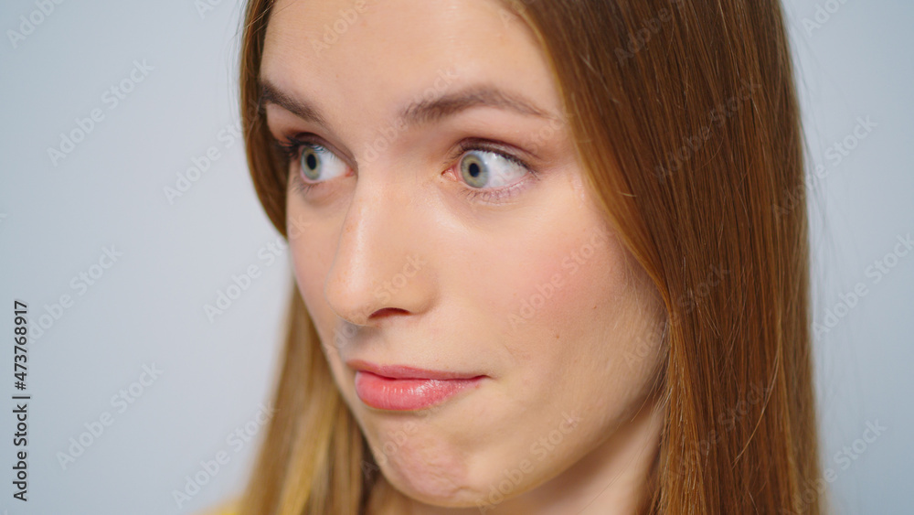 Closeup excited woman looking at camera on grey background in studio. Closeup excited woman looking at camera on grey background in studio.