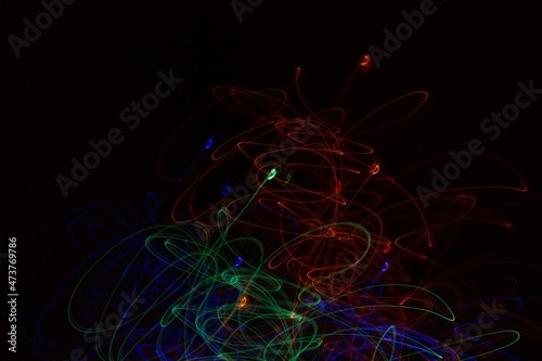 Multicolored neon lights on black background