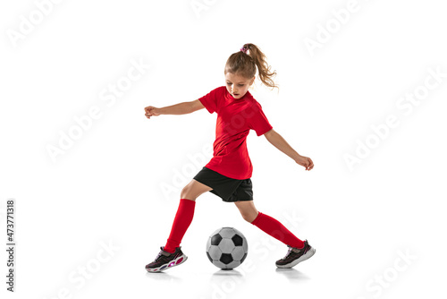 Quadro em tela Full-length portrait of little girl, child playing football, training, dribbling