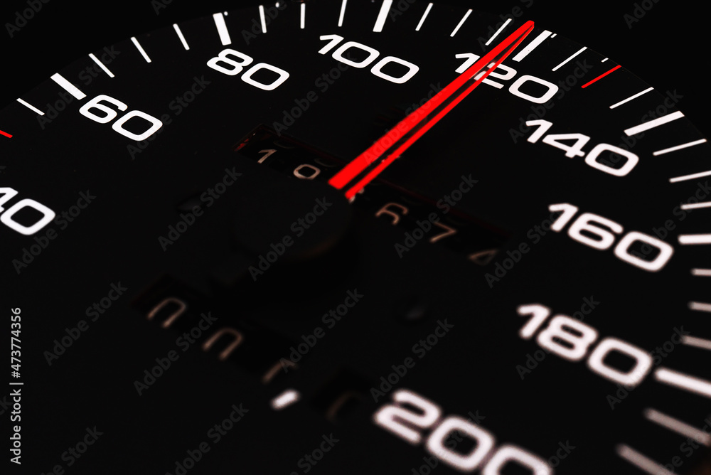 Car speedometer with the needle pointing a high speed at blackground, Speedometer with a red arrow indicating speeding, conceptual image for excessive speeding or careless driving concept.Close-up. Car speedometer with the needle pointing a high speed at blackground, Speedometer with a red arrow indicating speeding, conceptual image for excessive speeding or careless driving concept.Close-up.