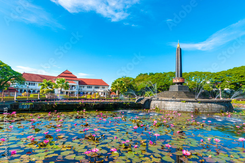 Malang Tugu Square with blue sky and beautiful garden flower park is located in front of City Hall (Balai Kota). It is also called as Round Square since due to it's round shape (Alun-alun Bunder) photo