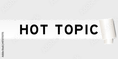 Ripped gray paper background that have word hot topic under torn part