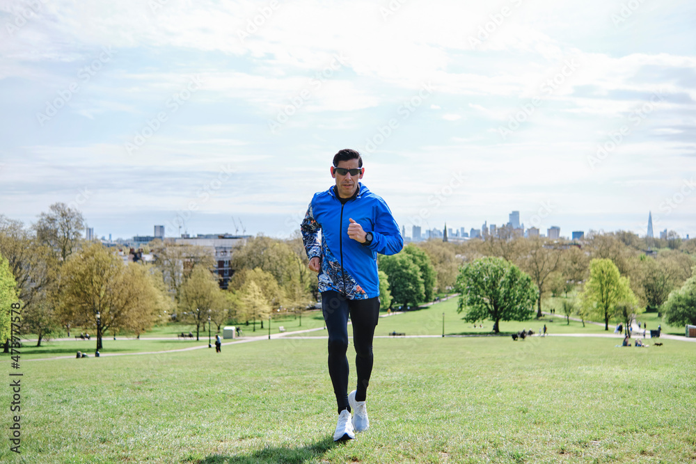 Man running at public park during sunny day Man running at public park during sunny day