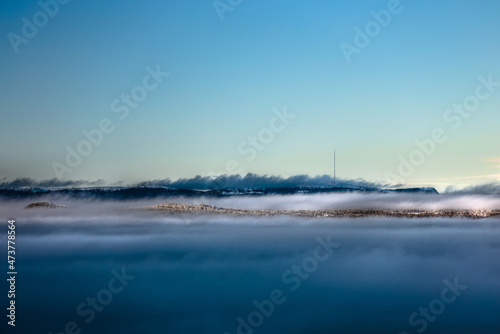 Dense fog and clouds in front of mountains