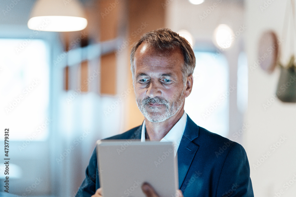 Businessman using digital tablet in office Businessman using digital tablet in office