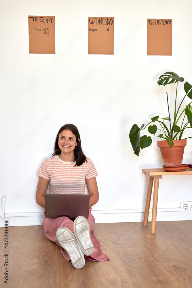 Smiling businesswoman using laptop in office Smiling businesswoman using laptop in office