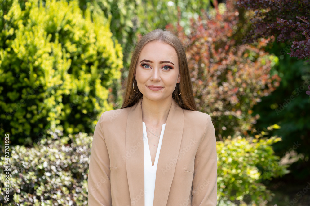 Portrait of smart, blonde, smiling woman in garden with professional, business image. Portrait of smart, blonde, smiling woman in garden with professional, business image.