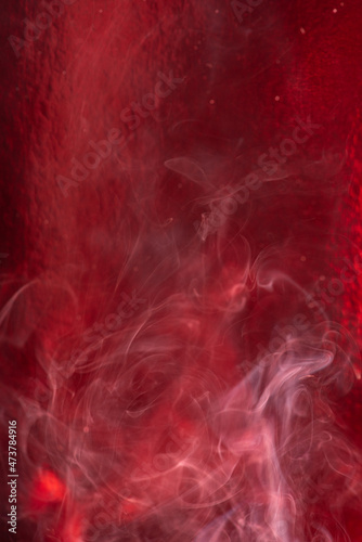 Smoke, smoke rising and creating beautiful shapes and a red background, Selective focus.