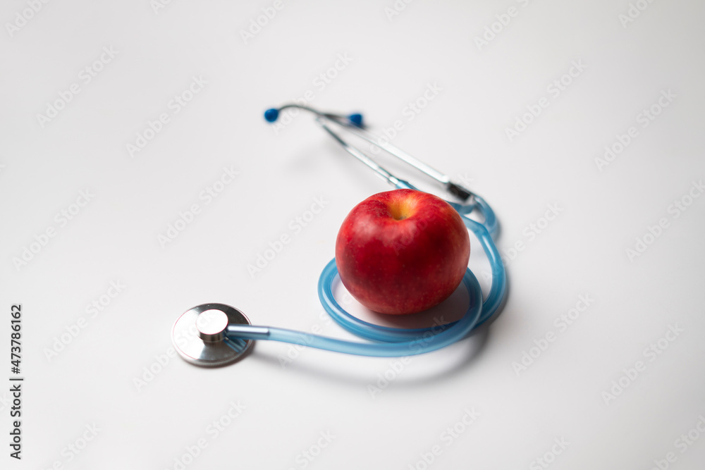 stethoscope and fresh raw fruit flat lay as the symbol of alternative medicine stethoscope and fresh raw fruit flat lay as the symbol of alternative medicine