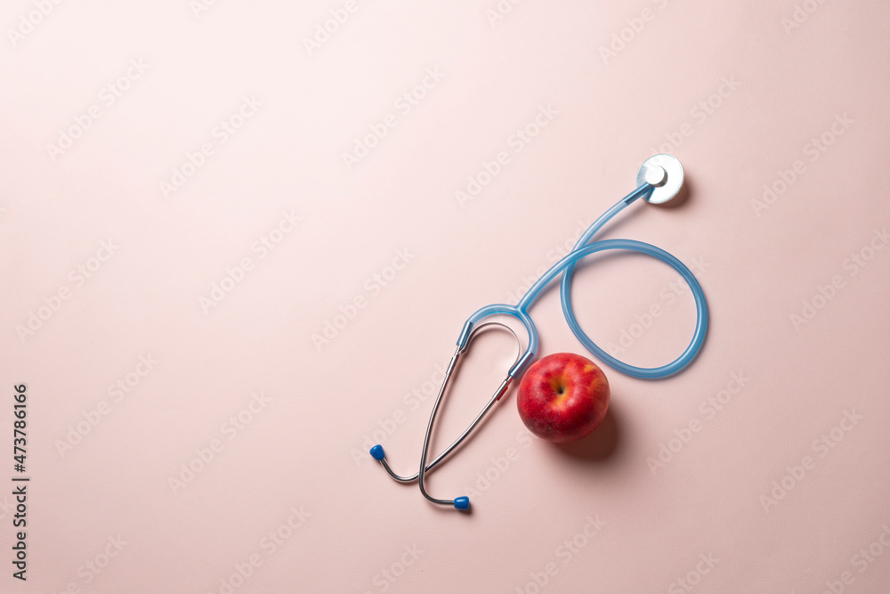 stethoscope and fresh raw fruit flat lay as the symbol of alternative medicine stethoscope and fresh raw fruit flat lay as the symbol of alternative medicine