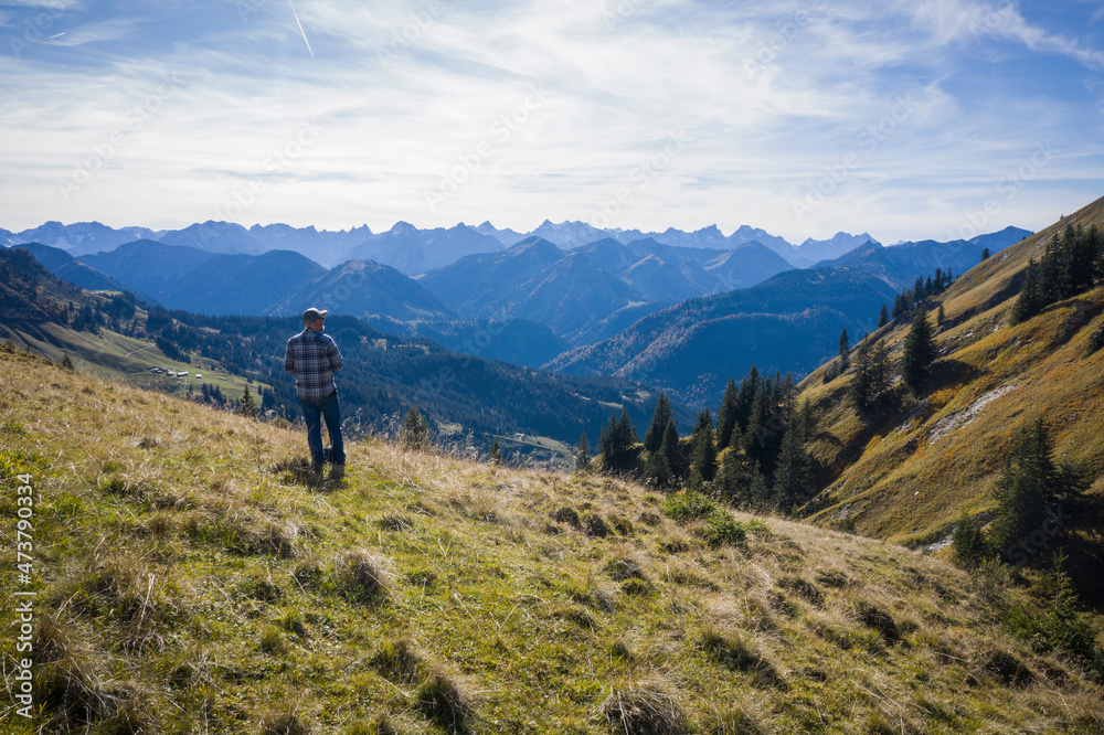 Austria, Tyrol, Eben am Achensee, Male hiker admiring green forested mountains in autumn Austria, Tyrol, Eben am Achensee, Male hiker admiring green forested mountains in autumn
