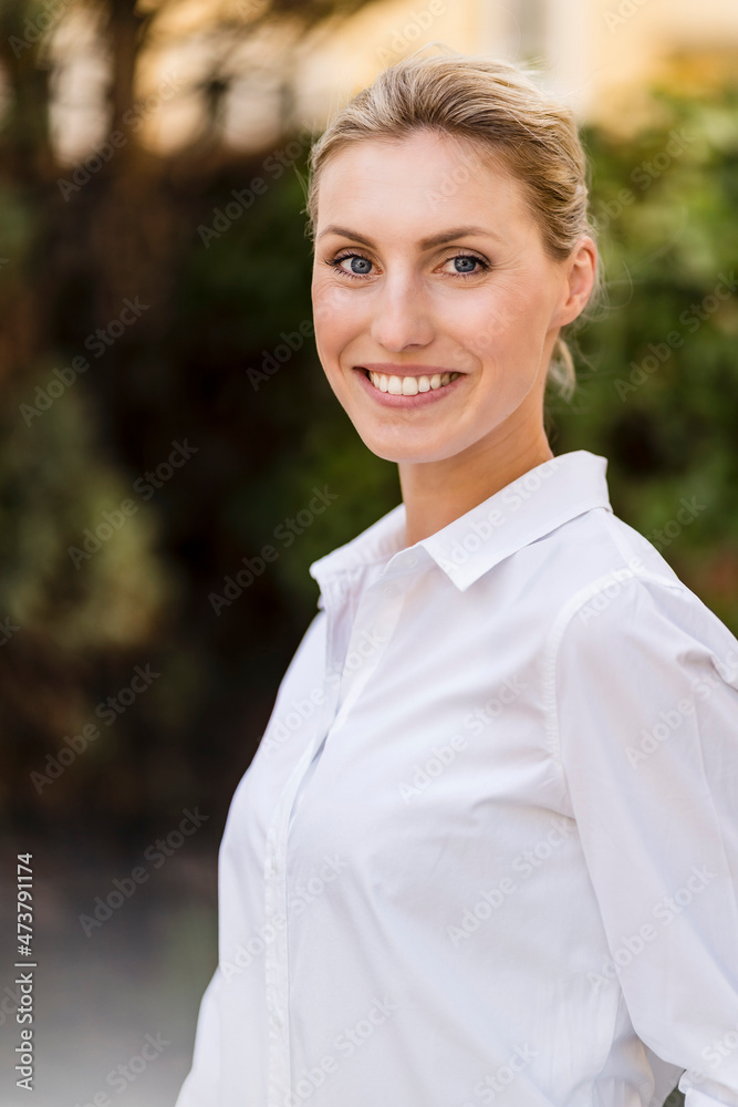 Smiling beautiful businesswoman with blond hair outdoors Smiling beautiful businesswoman with blond hair outdoors