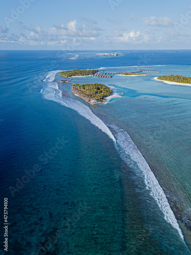Maldives, Aerial view of Naladhu island surrounded by blue waters of Indian Ocean photo