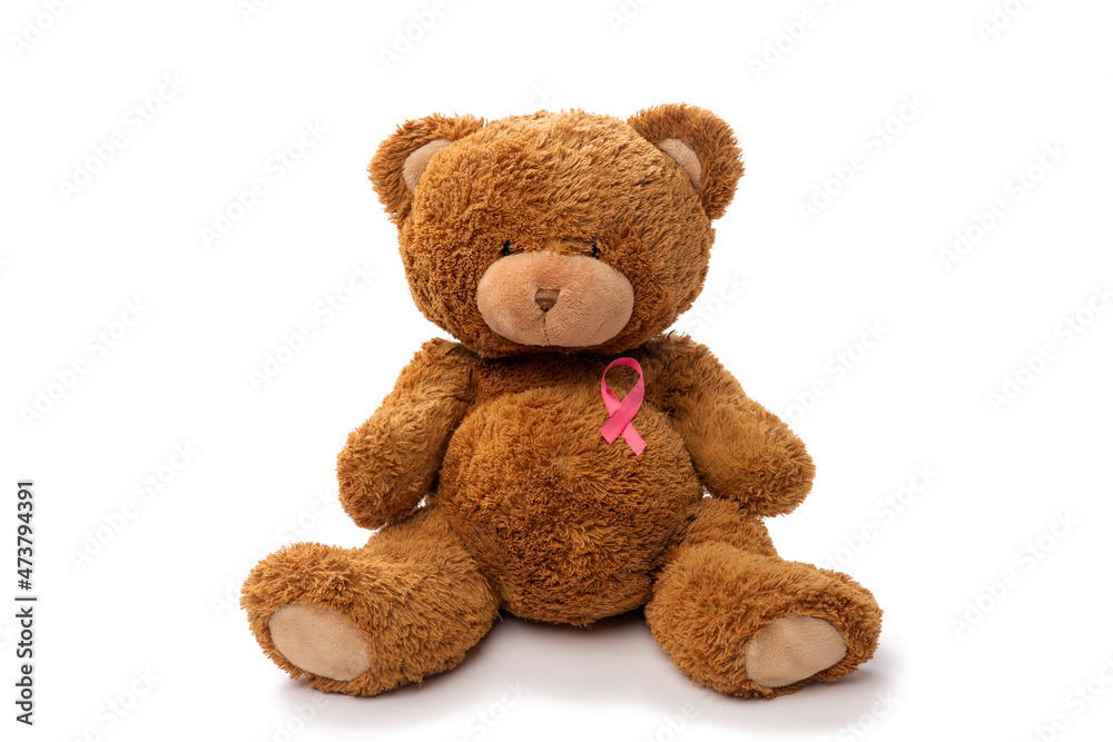 medicine, healthcare and oncology concept - teddy bear toy with pink breast cancer awareness ribbon on white background