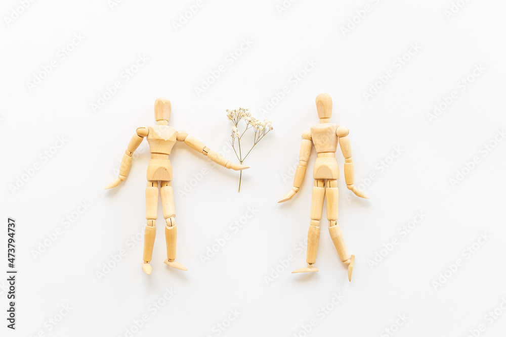 Couple of wooden figures - man and woman connection. Love and dating concept Couple of wooden figures - man and woman connection. Love and dating concept