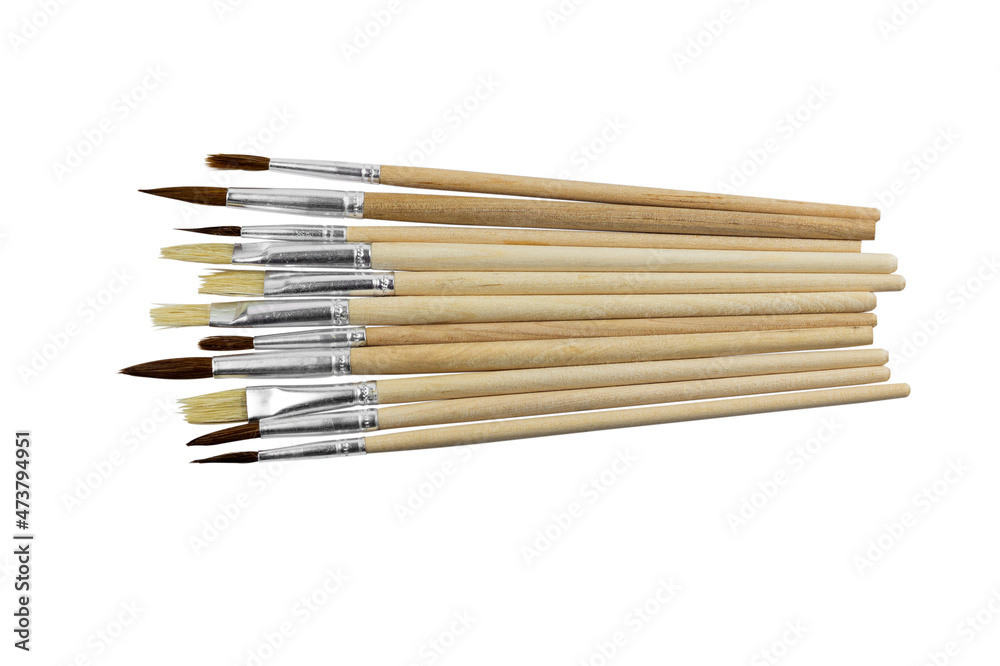 set of paint brushes in a row on white isolated background, copy space, top view