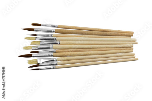 set of paint brushes in a row on white isolated background, copy space, top view