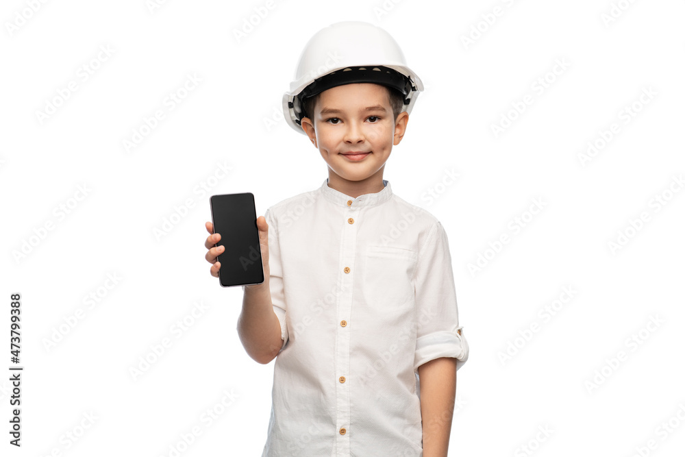 building, construction and profession concept - smiling little boy in helmet showing smartphone over white background building, construction and profession concept - smiling little boy in helmet showing smartphone over white background