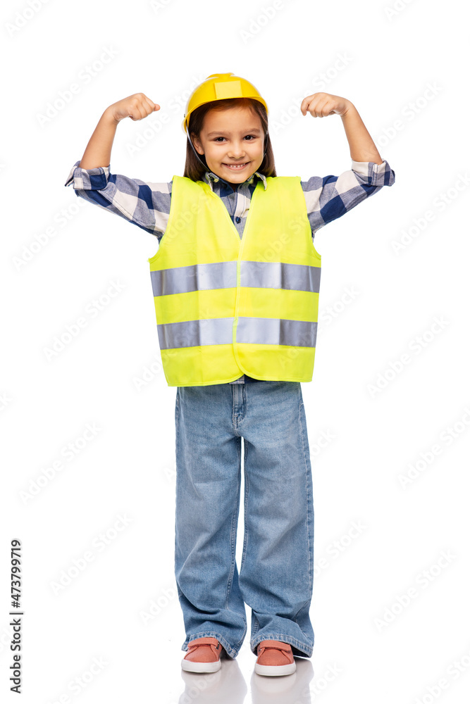 building, construction and girl power concept - smiling little girl in protective helmet and safety vest showing her strong arms over white background building, construction and girl power concept - smiling little girl in protective helmet and safety vest showing her strong arms over white background
