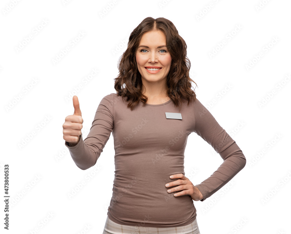 sale, shopping and business concept - happy female shop assistant with name tag showing thumbs up over white background sale, shopping and business concept - happy female shop assistant with name tag showing thumbs up over white background